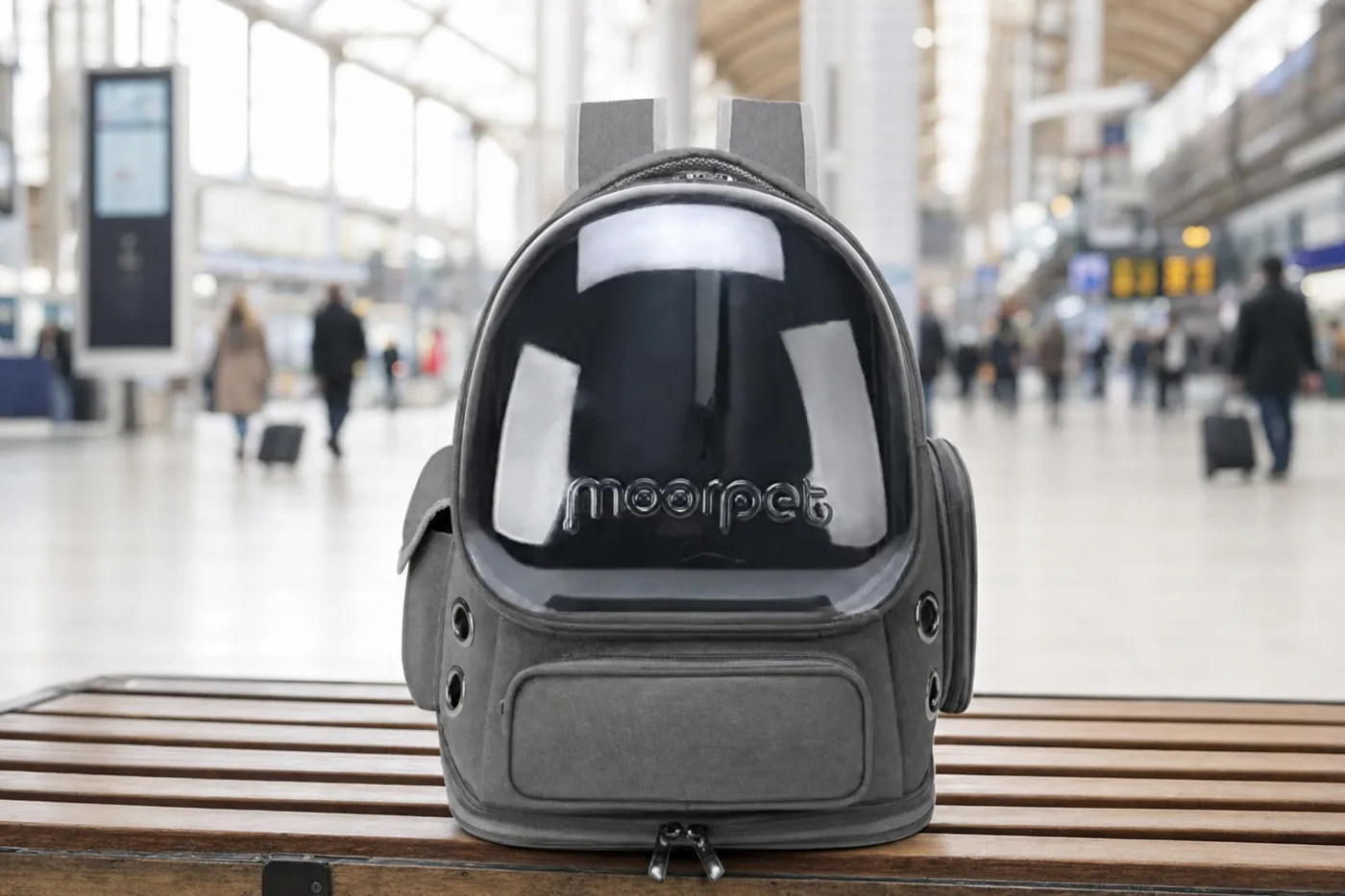 A soft bubble backpack resting on a bench inside a railway station concourse